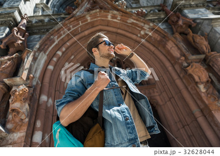 Happy youthful guy observing city attractions 32628044