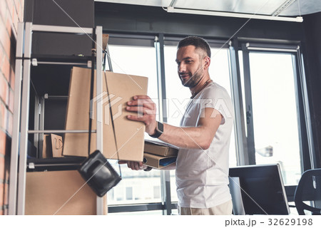 Trendy adult guy is laboring with documents 32629198