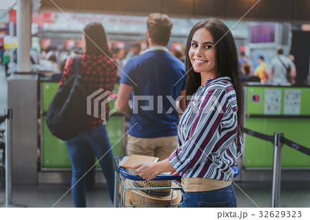 Cheerful lady going to check-in Cheerful lady going to check-in 32629323