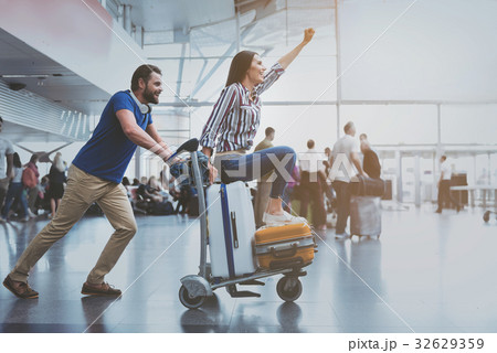 Hilarious smiling couple playing at terminal 32629359