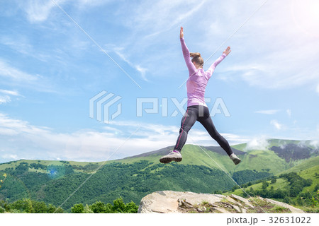 Young woman jumping in the mountains 32631022
