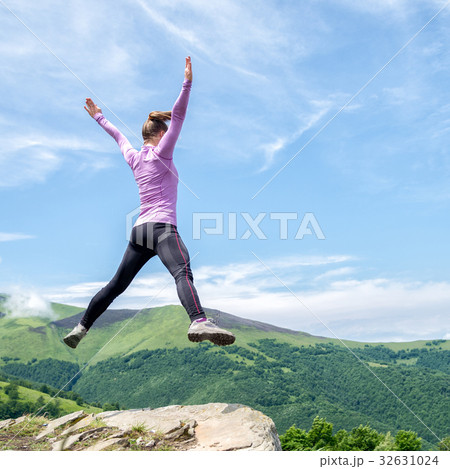 Young woman jumping in the mountains Young woman jumping in the mountains 32631024