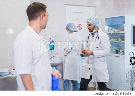 Surgeon gathered with his team of doctors before 32631633