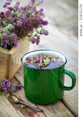 Enameled mug of thyme healing herbs. 32632130