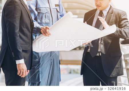 Engineer and business man discuss about blueprint Engineer and business man discuss about blueprint 32641916