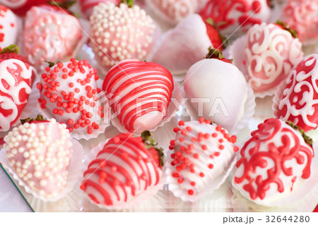 Strawberries dipped in white and pink glaze 32644280