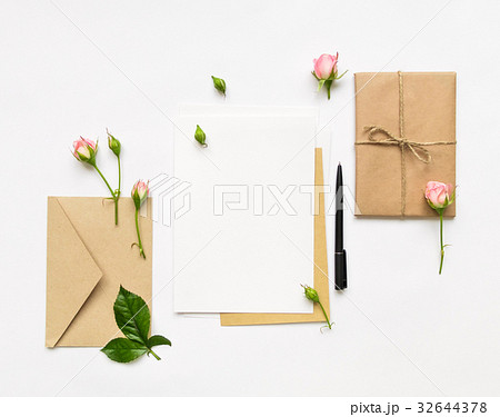 Letter, envelope and gift on white, flat lay Letter, envelope and gift on white, flat lay 32644378