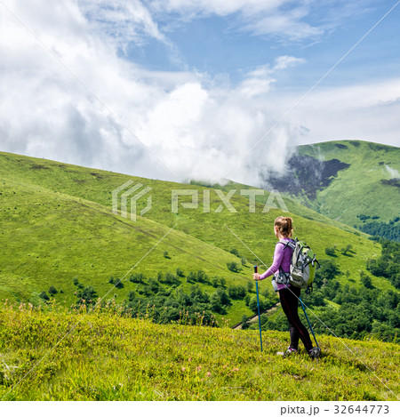 Young woman hiking in the mountains Young woman hiking in the mountains 32644773