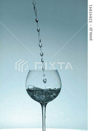 水を注がれるワイングラスの写真素材
