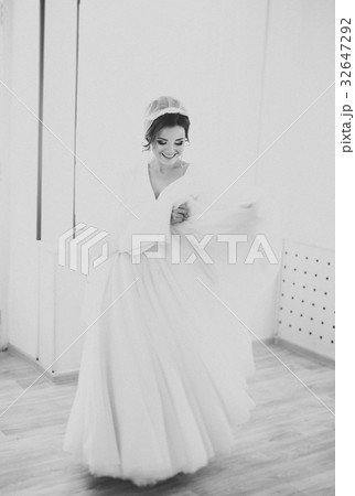 Gorgeous bride in robe posing and preparing for 32647292
