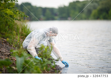 Ecologist takes sample of water 32647753