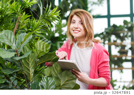 Young florist at flower shop Young florist at flower shop 32647891