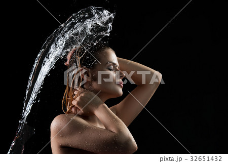 Sexy blonde enjoying water splash Sexy blonde enjoying water splash 32651432