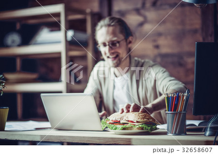 Man working at home going to eat at working place. 32658607