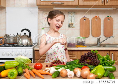 girl cooking in home kitchen fruit and vegetables 32658734