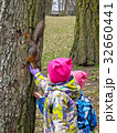 children feeding a squirrel 32660441