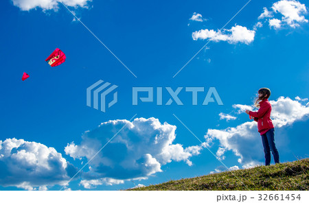 Young girl with kite flying in the sky 32661454