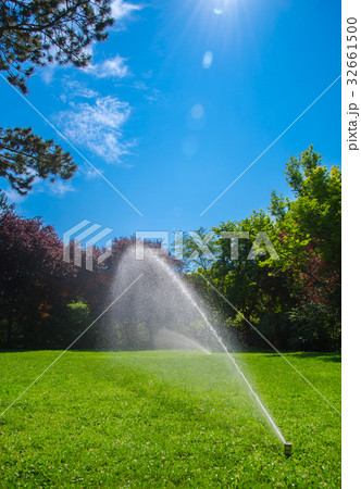 Lawn Sprinkler with Water and Blue Sky Lawn Sprinkler with Water and Blue Sky 32661500