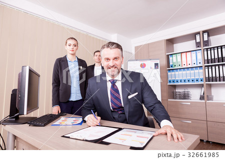 Adult businessman writing on folder with papper 32661985