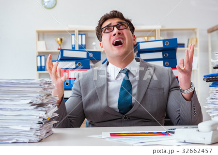 Businessman busy with much paperwork Businessman busy with much paperwork 32662457