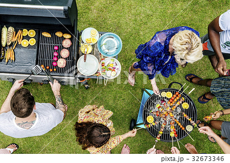 Group of diverse friends grilling barbecue outdoors 32673346