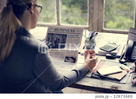 Businesspeople Reading Newspaper at Office Updating News 32673660