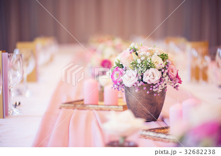 Beautiful table set with flowers and glass cups. 32682238