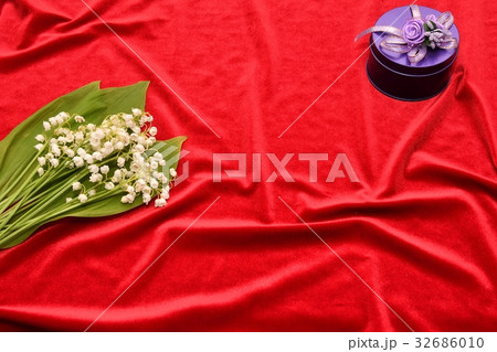 Flower of the Valley on a red background Flower of the Valley on a red background 32686010