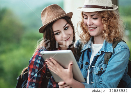 Two girls in hats traveling through ruins 32688982