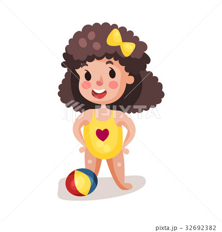 Little boy wearing yellow swimsuit playing with a 32692382