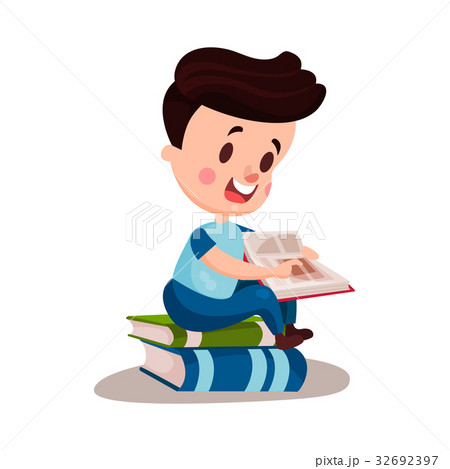 Cute boy reading a book sitting on a pile of books Cute boy reading a book sitting on a pile of books 32692397