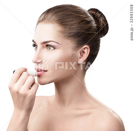 Beautiful woman applying hygienic lip balm. 32693308