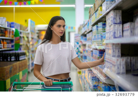 woman shopping in a grocery store supermarket woman shopping in a grocery store supermarket 32693779