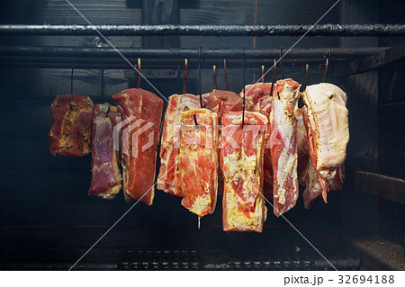 Hanging ham in the smokehouse 32694188