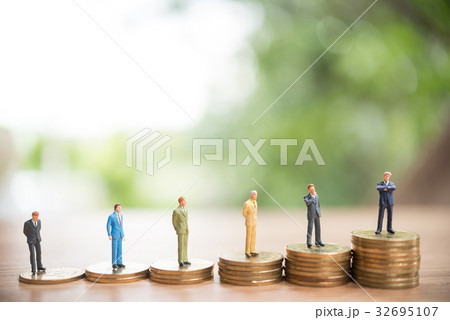 Miniature people standing on stack of coin, Miniature people standing on stack of coin, 32695107