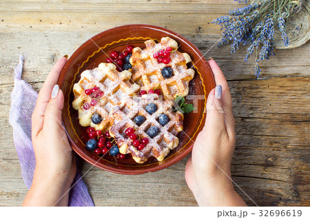 Female serving homemade waffles fresh berry fruit Female serving homemade waffles fresh berry fruit 32696619