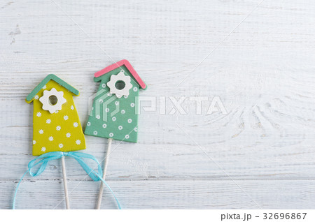 Green birdhouses on the white wooden background Green birdhouses on the white wooden background 32696867