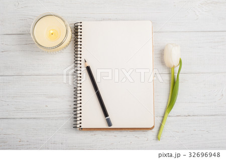Open notebook, pencil, candle and tulip Open notebook, pencil, candle and tulip 32696948