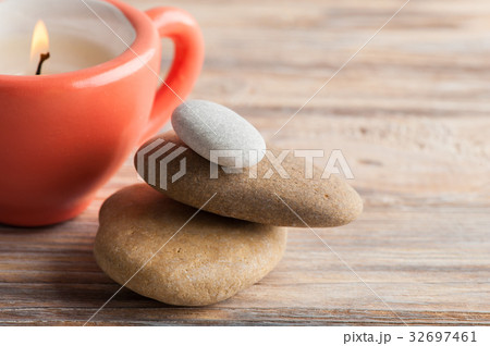 Candle in coral cup over shabby wooden background Candle in coral cup over shabby wooden background 32697461