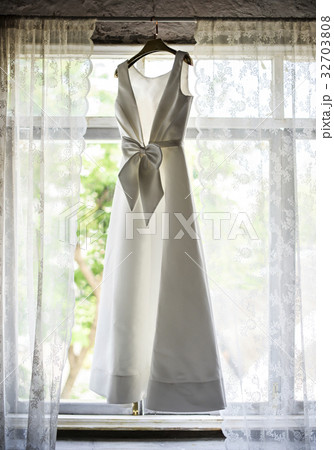 White Wedding Dress Hanging by the Window White Wedding Dress Hanging by the Window 32703808