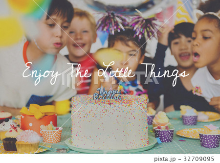 Group of diverse children blowing birthday cake together Group of diverse children blowing birthday cake together 32709095