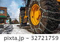 Tractor tires with chains in the snow. 32721759