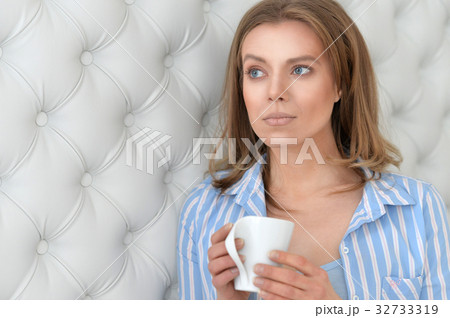 beautiful young woman with white cup 32733319