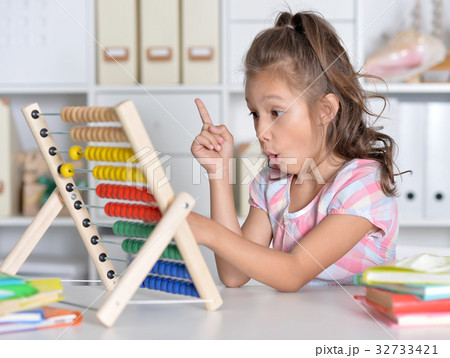 little girl counting on abacus 32733421