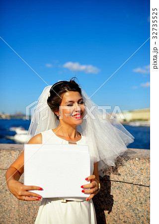 Portrait of a bride with plate on quay Neva river, Saint-Petersburg 32735525