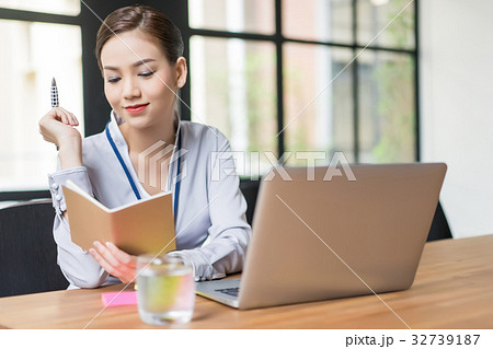 The woman is looking at the notebook. 32739187