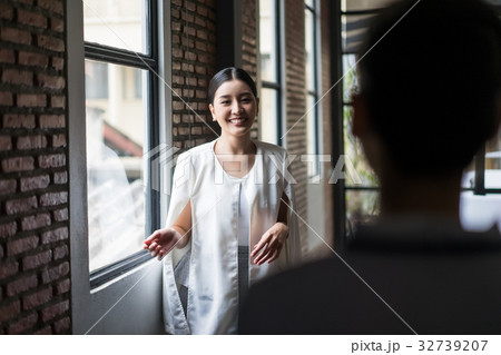 A woman is looking at someone and smiling 32739207