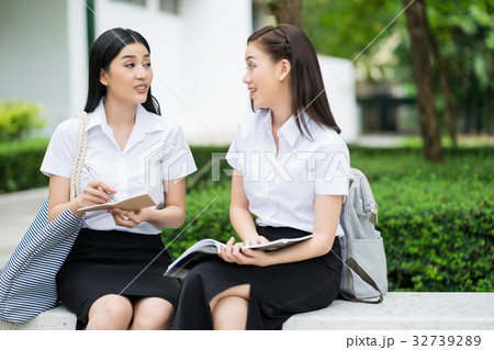 Two university students are sitting, studying in the campus 32739289