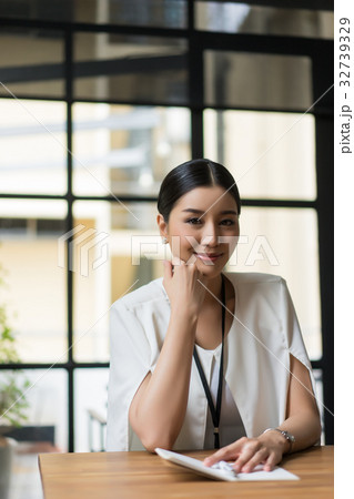 a portrait of woman with chin on hand and looking at camera a portrait of woman with chin on hand and looking at camera 32739329
