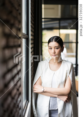 a serious woman is standing and crossing her arms a serious woman is standing and crossing her arms 32739330